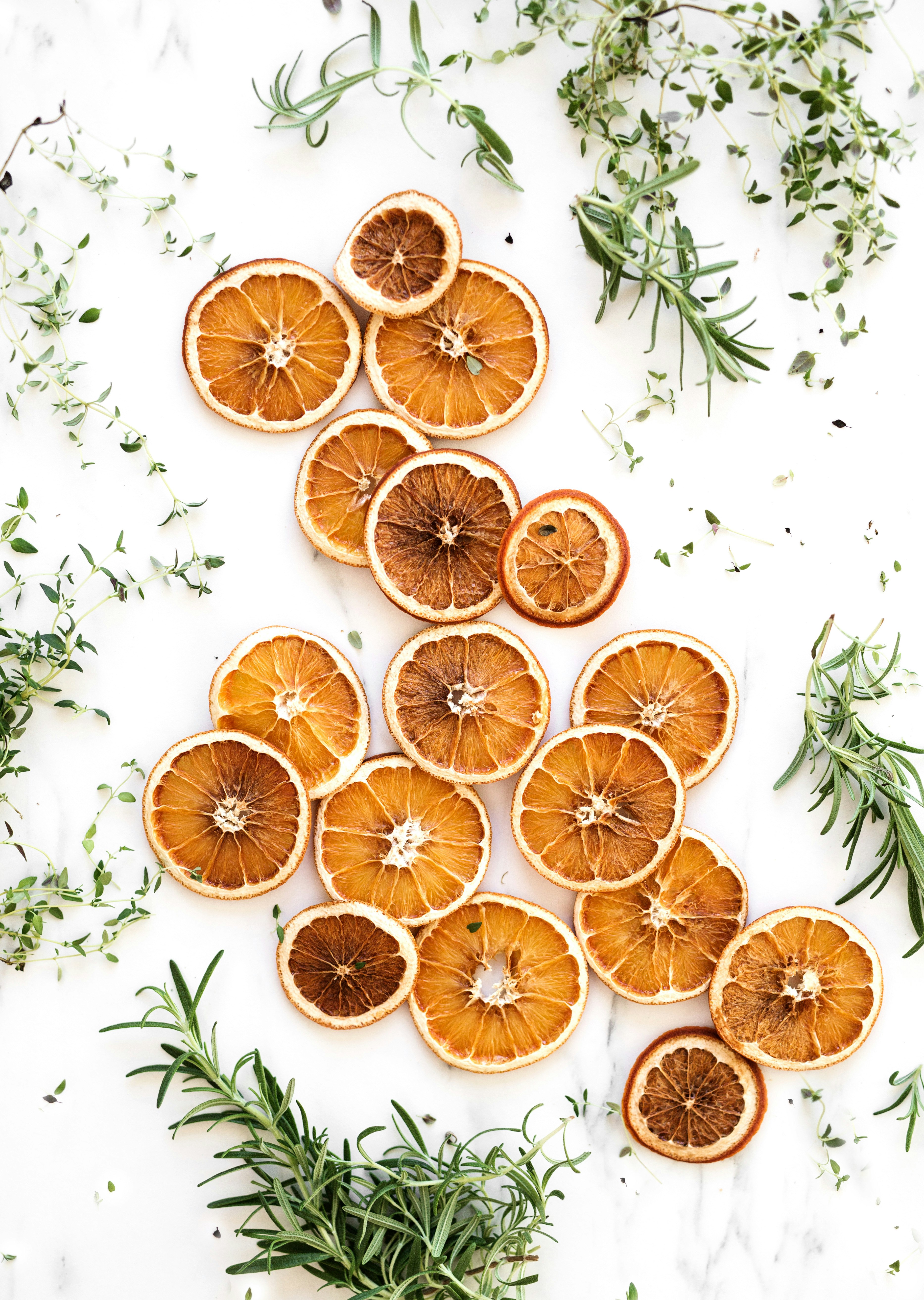sliced lemons surrounded by green herbs
